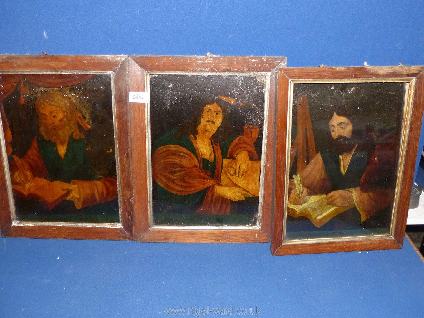 Three wooden framed paintings on glass depicting gentlemen sat writing.