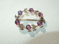 A 9ct gold circular brooch, 6 set purple stones, Chester date letter 'K', possibly 1910,