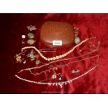 A terracotta coloured jewellery case containing a quantity of costume jewellery including necklace,