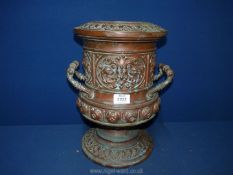 A two handled urn style vase with embossed mask head detail, etc.