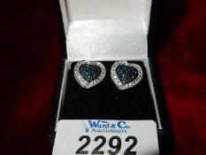 A pair of sterling silver, blue and white diamond earrings.