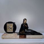 Manner of Menneville and Rochard, a 1920's art deco marble, spelter and ivorine clock,