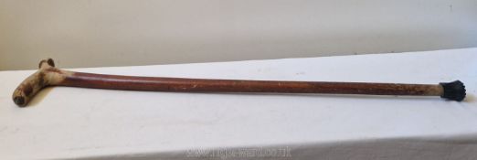 A characterful old country made walking stick carved from a single piece of wood,