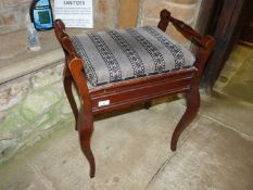 A Victorian Mahogany piano stool with practice books.