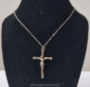 An early 20th century silver crucifix pendant modelled as Christ on the cross 'INRI' above