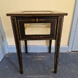 A 20th century virtue display table, dark wood with gilt highlights (lock requites attention).