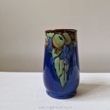 A Royal Doulton Lambeth art deco vase painted with apples and grapes in low relief against a blue