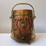 A very fine and interesting art nouveau copper coal bucket with swing handle and raised floral