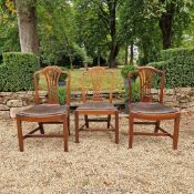 Three Georgian mahogany standard chairs in the Hepplewhite style,