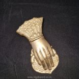 A heavy Edwardian gilt metal letter clip in the shape of a lady’s hand; some damage to gilding.