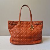 Dior: A leather 'cannage' tote Bag made from orange coated canvas with leather trim and gilt metal