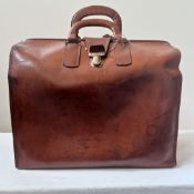 A fine 1920's-30's leather Gladstone bag labelled to interior 'Supplied By McCready Wilson and Co,