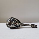 A faux tortoiseshell and pewter inlaid miniature mandolin with musical movement,