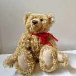 A Steiff teddy bear with button, label and growler, 13 ins high (sitting).