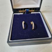 A pair chip diamond ear studs set in unmarked yellow metal, probably gold.