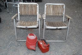 Pair of aluminium and wooden garden chairs, fuel can and watering cans.