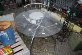 A glass top circular table, 35 1/2" wide with a bar stool.