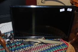 A Samsung 23" screen and remote.