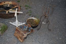 A cast iron stand, pot stand, enamel cook pot and vice.