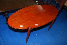 An oval stained coffee table.