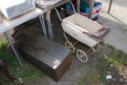 A vintage doll's pram and a metal drawer cabinet.