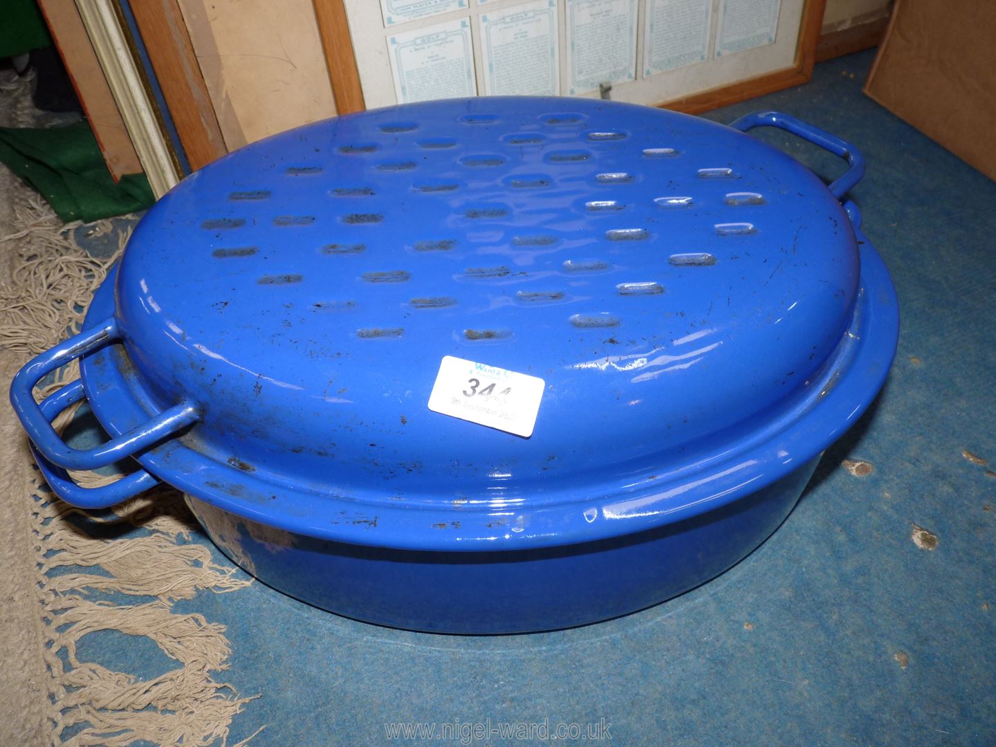 A blue and white large enamel le Creuset style lidded casserole pot.