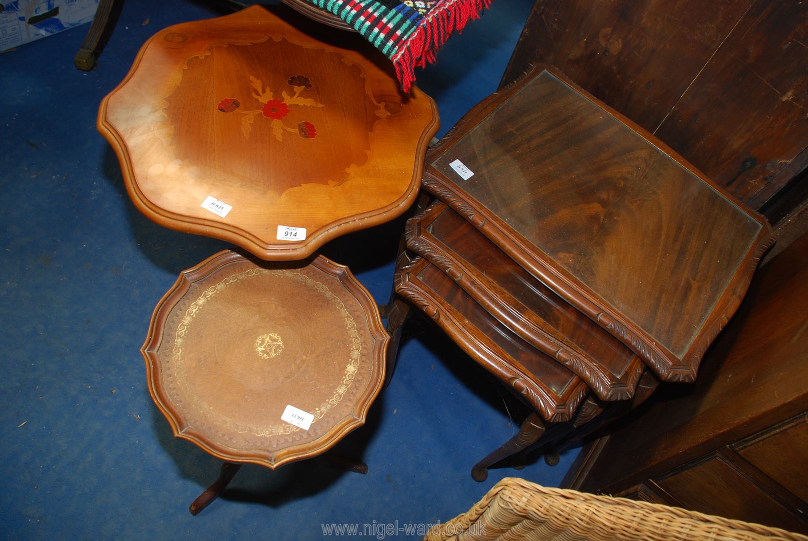 A nest of 3 glass top tables and 2 occasional tables.