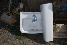 A pedestal hand basin with tap.