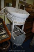 Two wicker effect rocking cribs in grey and white.
