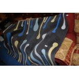 A contemporary rug, blue/white/yellow design on grey ground 7' 5" x 5'.