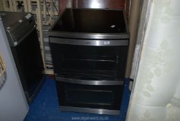 A four ring AEG electric twin oven cooker with induction hob 23½" x 25" x 3' high.