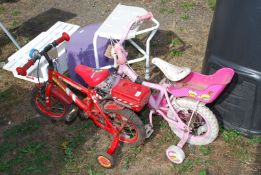 Two children's bikes with stabilisers.