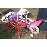 Two children's bikes with stabilisers.