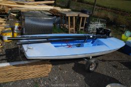 A Topper sailing dinghy with mast, includes trailer, approx. 134" long x 46 1/2" wide.