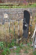 A skate board and a garden gate.