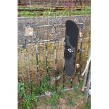 A skate board and a garden gate.