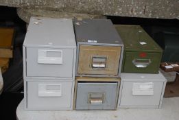 Six small metal filing drawers.