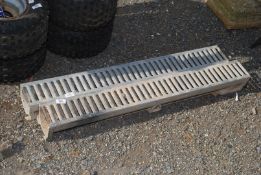 Two ground level gullies with grating, 39" long.