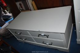 A low four drawer white unit 50" x 23½" x 23".