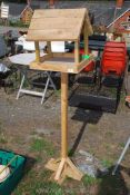 A wooden bird table.