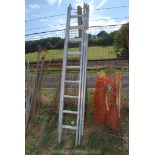 A three section extension aluminium ladder.