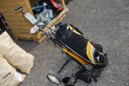 A Golf trolley, golf bag and 3 wedges, 10 irons (13), balls etc.