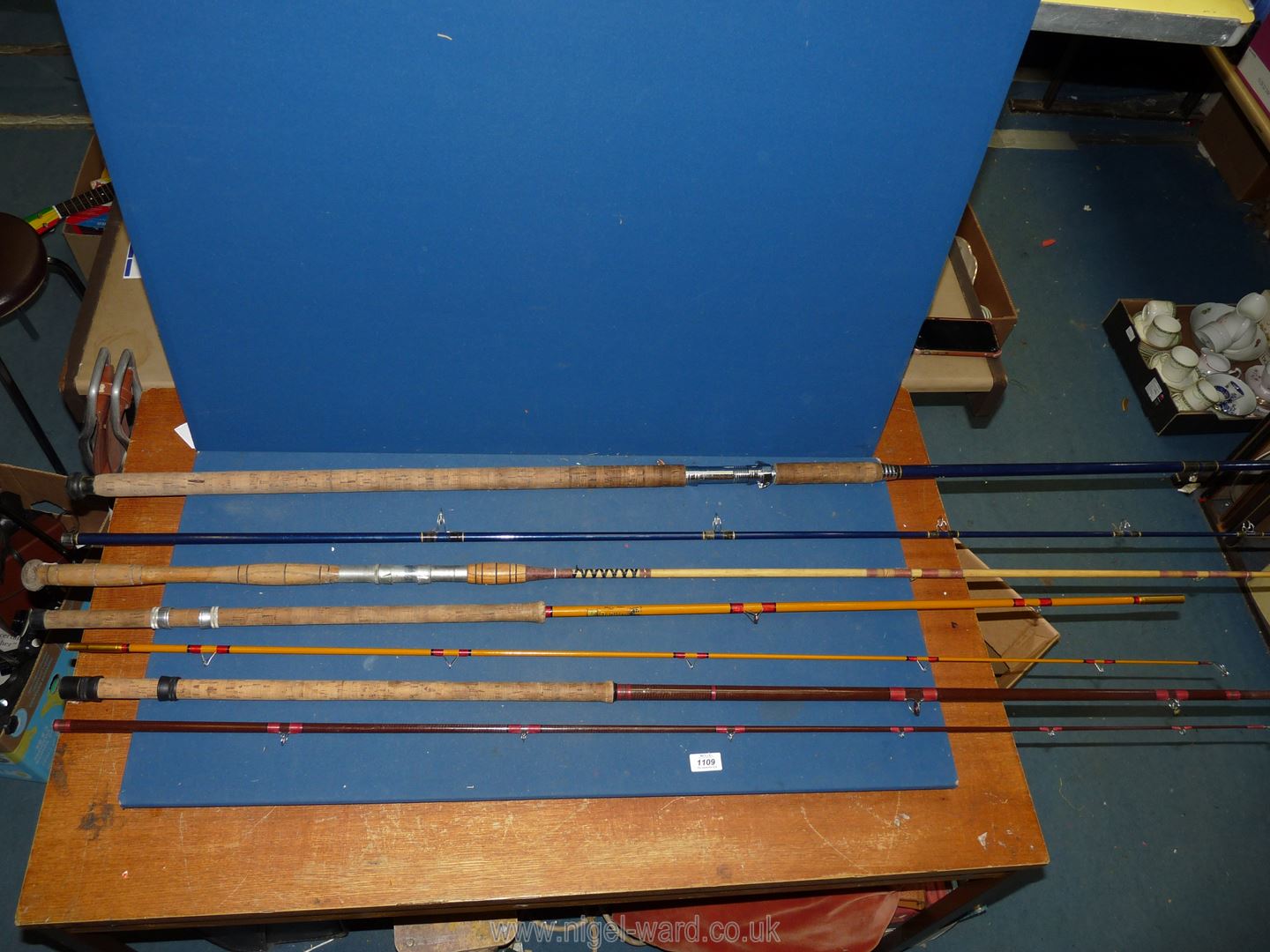 A quantity of fishing rods including Paragon 60-1 fishing rod, 7' fibreglass rod,