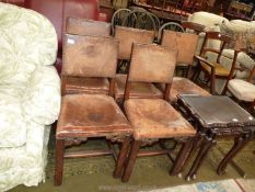 A set of five Oak framed and leather upholstered Dining Chairs with brass studs and including one