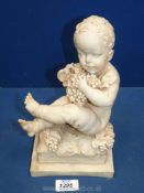 An Alabaster figure of a child with grapes 10 1/4" tall.