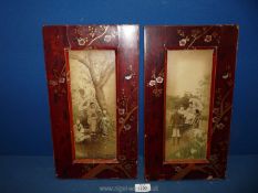 A pair of oriental lacquered frames with gilt and cherry blossom detail.