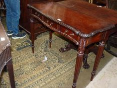 A dark Mahogany serpentine fronted Side Table having three frieze drawers and standing on turned
