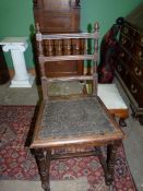 An Oak finished arts and crafts side Chair having turned spindles and acorn finials to the back,