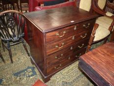 A compact Oak carcassed Georgian Mahogany Chest of four long Drawers standing on bracket feet,