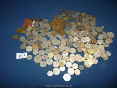 A quantity of coins; mostly foreign, plus a bronze medal/plaque.